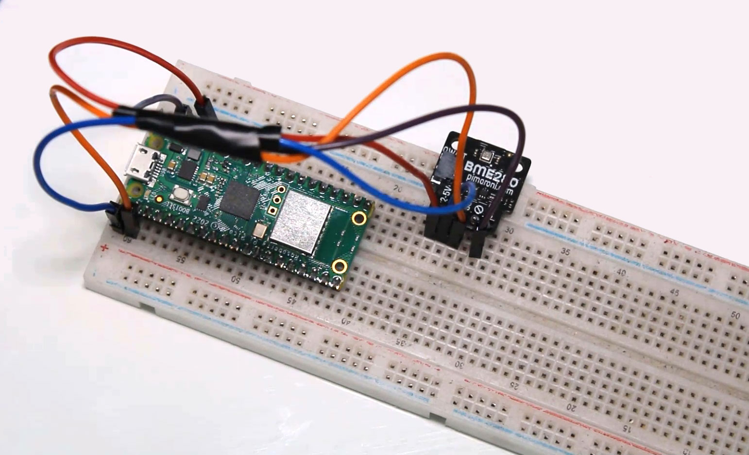 Image of Pi Pico W on a breadboard with jumper cables to connect it to the BME280 sensor